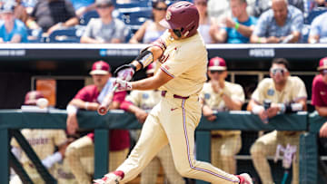 Jun 18, 2024; Omaha, NE, USA; Florida State Seminoles center fielder Max Williams (18) hits a single against the North Carolina Tar Heels during the fourth inning at Charles Schwab Field Omaha. Mandatory Credit: Dylan Widger-Imagn Images