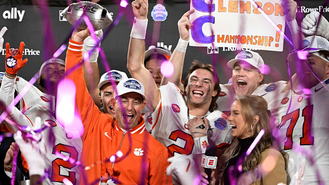Dec 7, 2024; Charlotte, NC, USA; Clemson Tigers head coach Dabo Swinney, quarterback Cade Klubnik (2) and teammates celebrate after winning the 2024 ACC Championship game against the Southern Methodist Mustangs at Bank of America Stadium. Mandatory Credit: Bob Donnan-Imagn Images