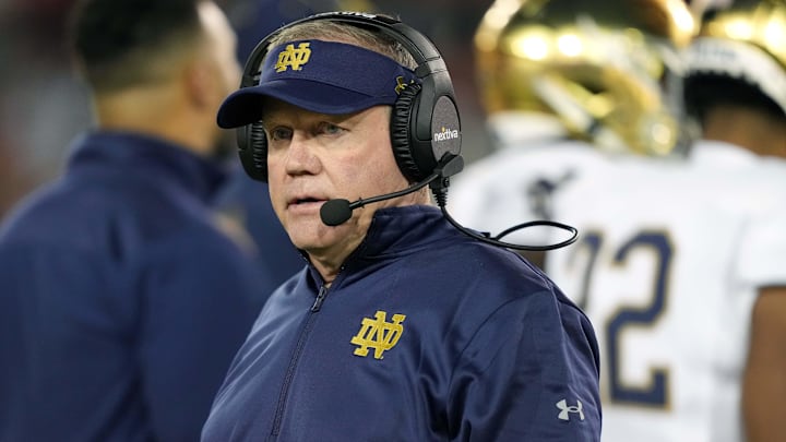 Nov 27, 2021; Stanford, California, USA; Notre Dame Fighting Irish head coach Brian Kelly walks on the field during the second quarter against the Stanford Cardinal at Stanford Stadium. Mandatory Credit: Darren Yamashita-Imagn Images