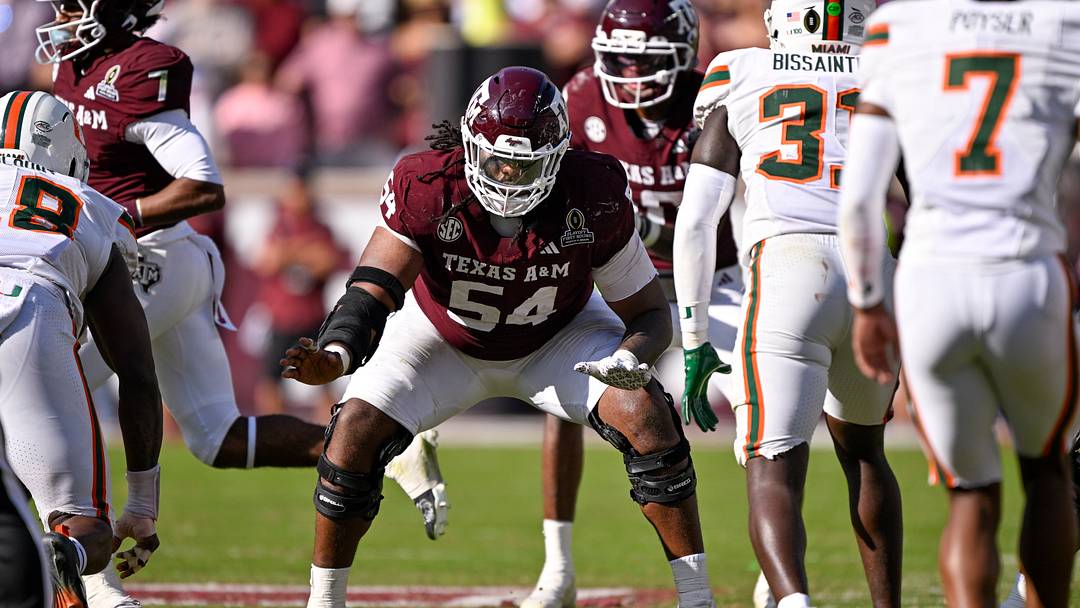 Dec 20, 2025; College Station, TX, USA; Texas A&M Aggies offensive lineman Mark Nabou Jr. (54) snaps the ball during the game between the Aggies and the Hurricanes at Kyle Field. Mandatory Credit: Jerome Miron-Imagn Images