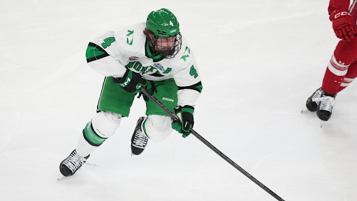 Apr 9, 2026; Las Vegas, Nevada, UNITED STATES; North Dakota Fighting Hawks defenseman Jake Livanavage (4) moves the puck in the second period against the Wisconsin Badgers in the semifinals of the NCAA men's ice hockey Frozen Four at T-Mobile Arena. Mandatory Credit: Lucas Peltier-Imagn Images