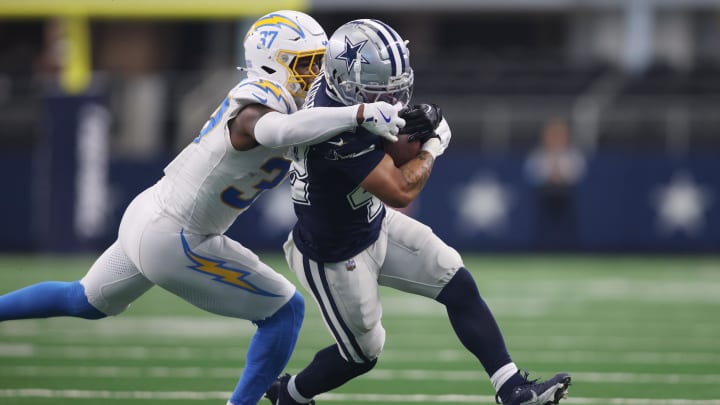 Aug 24, 2024; Arlington, Texas, USA; Los Angeles Chargers safety Thomas Harper (37) grabs the facemask of Dallas Cowboys running back Deuce Vaughn (42) in the first half at AT&T Stadium. Mandatory Credit: Tim Heitman-USA TODAY Sports