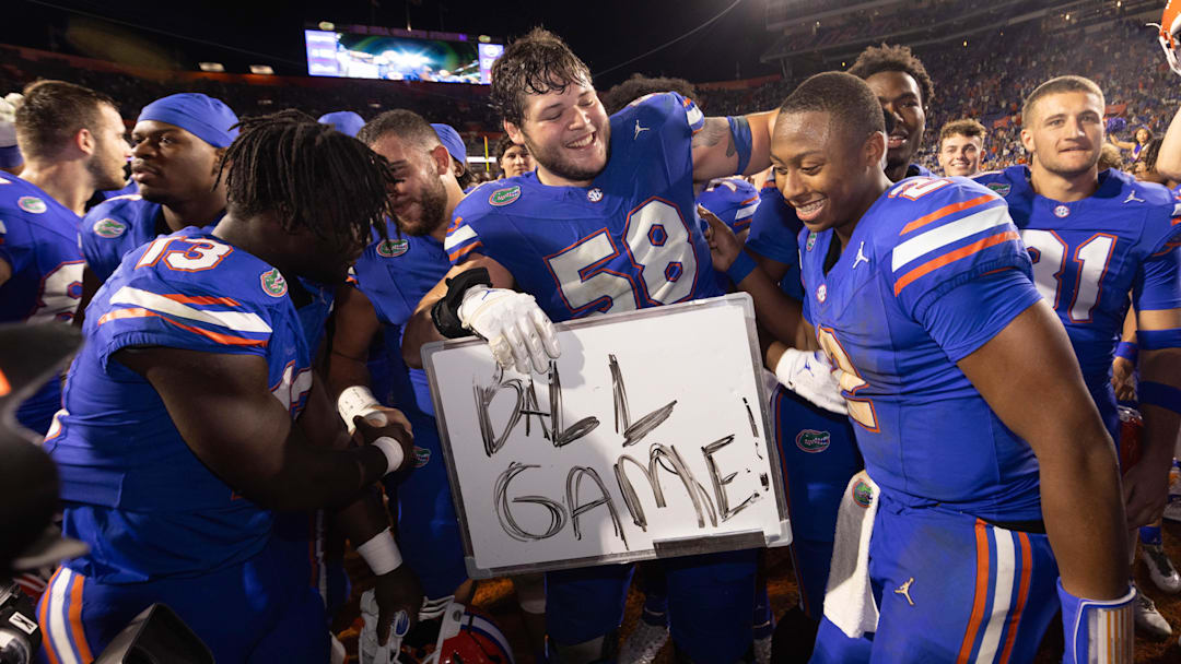 Florida Gators offensive lineman Austin Barber (58) pulls in Florida Gators quarterback DJ Lagway (2) as the Gators celebrated at Ben Hill Griffin Stadium in Gainesville, FL on Saturday, November 16, 2024. The Gators defeated the Tigers 27-16. [Doug Engle/Gainesville Sun]