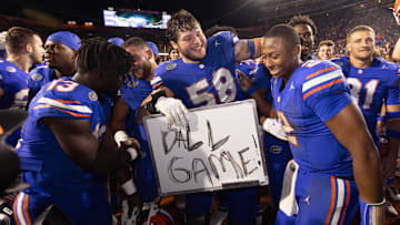 Florida Gators offensive lineman Austin Barber (58) pulls in Florida Gators quarterback DJ Lagway (2) as the Gators celebrated at Ben Hill Griffin Stadium in Gainesville, FL on Saturday, November 16, 2024. The Gators defeated the Tigers 27-16. [Doug Engle/Gainesville Sun]