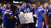 Florida Gators offensive lineman Austin Barber (58) pulls in Florida Gators quarterback DJ Lagway (2) as the Gators celebrated at Ben Hill Griffin Stadium in Gainesville, FL on Saturday, November 16, 2024. The Gators defeated the Tigers 27-16. [Doug Engle/Gainesville Sun]
