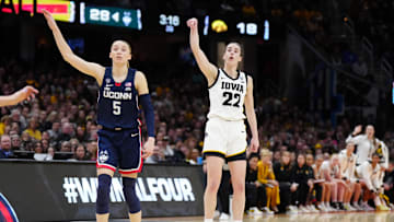 Apr 5, 2024; Cleveland, OH, USA; Iowa Hawkeyes guard Caitlin Clark (22) and Connecticut Huskies guard Paige Bueckers (5) react in the second quarter in the semifinals of the Final Four of the womens 2024 NCAA Tournament at Rocket Mortgage FieldHouse. Mandatory Credit: Kirby Lee-Imagn Images
