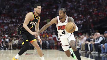Mar 12, 2025; Houston, Texas, USA; Houston Rockets guard Jalen Green (4) dribbles the ball as Phoenix Suns guard Devin Booker (1) defends during the third quarter at Toyota Center. Mandatory Credit: Troy Taormina-Imagn Images