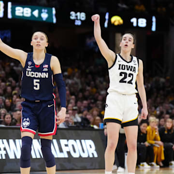 Iowa Hawkeyes guard Caitlin Clark (22) and Connecticut Huskies guard Paige Bueckers.