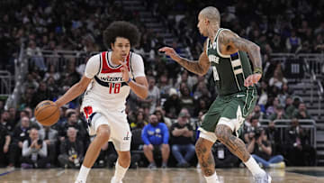 Oct 22, 2025; Milwaukee, Wisconsin, USA; Washington Wizards forward Kyshawn George (18) brings the ball up the court against Milwaukee Bucks forward Kyle Kuzma (18) in the second half at Fiserv Forum. Mandatory Credit: Michael McLoone-Imagn Images