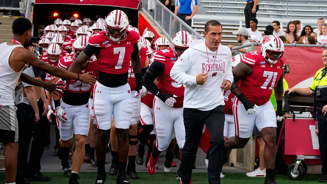 Sep 12, 2026; Madison, Wisconsin, USA; Wisconsin Badgers head coach Luke Fickell leads the team onto the field for warmups prior to the game against the Western Illinois Leathernecks at Camp Randall Stadium. Mandatory Credit: Jeff Hanisch-Imagn Images Sep 12, 2026; Madison, Wisconsin, USA; Wisconsin Badgers head coach Luke Fickell leads the team onto the field for warmups prior to the game against the Western Illinois Leathernecks at Camp Randall Stadium. Mandatory Credit: Jeff Hanisch-Imagn Images