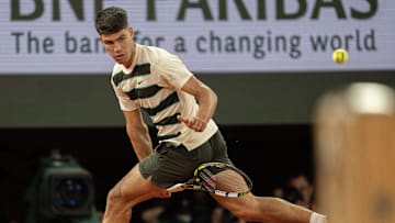 Carlos Alcaraz of Spain returns a shot during his match against Fabian Marozsan of Hungary at the 2025 French Open