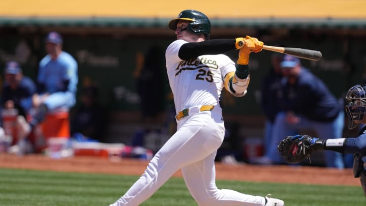 Jun 9, 2024; Oakland, California, USA; Oakland Athletics designated hitter Brent Rooker (25) hits a home run against the Toronto Blue Jays during the sixth inning at Oakland-Alameda County Coliseum. Mandatory Credit: Darren Yamashita-USA TODAY Sports