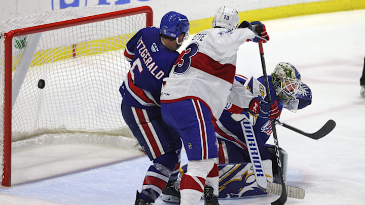 Amerks goalie Aaron Dell is pressure near the crease on this game winning goal by Laval  s Jean-Sebastien Dea int the 3rd overtime.  The Rockets win the North Division Finals 3 games to none.