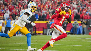 Dec 8, 2024; Kansas City, Missouri, USA; Kansas City Chiefs wide receiver Xavier Worthy (1) runs the ball as Los Angeles Chargers cornerback Cam Hart (20) defends during the first half at GEHA Field at Arrowhead Stadium. Mandatory Credit: Denny Medley-Imagn Images