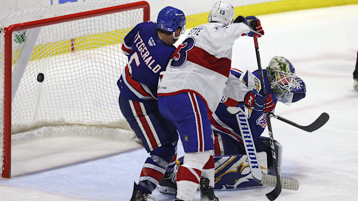 Amerks goalie Aaron Dell is pressure near the crease on this game winning goal by Laval  s Jean-Sebastien Dea int the 3rd overtime.  The Rockets win the North Division Finals 3 games to none.
