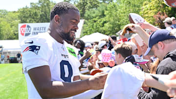 Jul 23, 2025; Foxborough, MA, USA; New England Patriots wide receiver Kayshon Boutte (9) signs an autograph for a fan after practice during day one of training camp at Gillette Stadium. Mandatory Credit: Eric Canha-Imagn Images