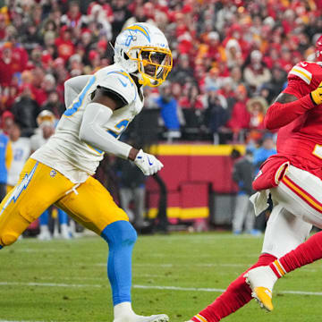 Dec 8, 2024; Kansas City, Missouri, USA; Kansas City Chiefs wide receiver Xavier Worthy (1) runs the ball as Los Angeles Chargers cornerback Cam Hart (20) defends during the first half at GEHA Field at Arrowhead Stadium. Mandatory Credit: Denny Medley-Imagn Images