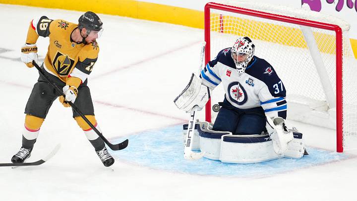 Apr 13, 2026; Las Vegas, Nevada, USA; Winnipeg Jets goaltender Connor Hellebuyck (37) makes a save against a deflection by Vegas Golden Knights right wing Reilly Smith (19) during the third period at T-Mobile Arena. Mandatory Credit: Stephen R. Sylvanie-Imagn Images