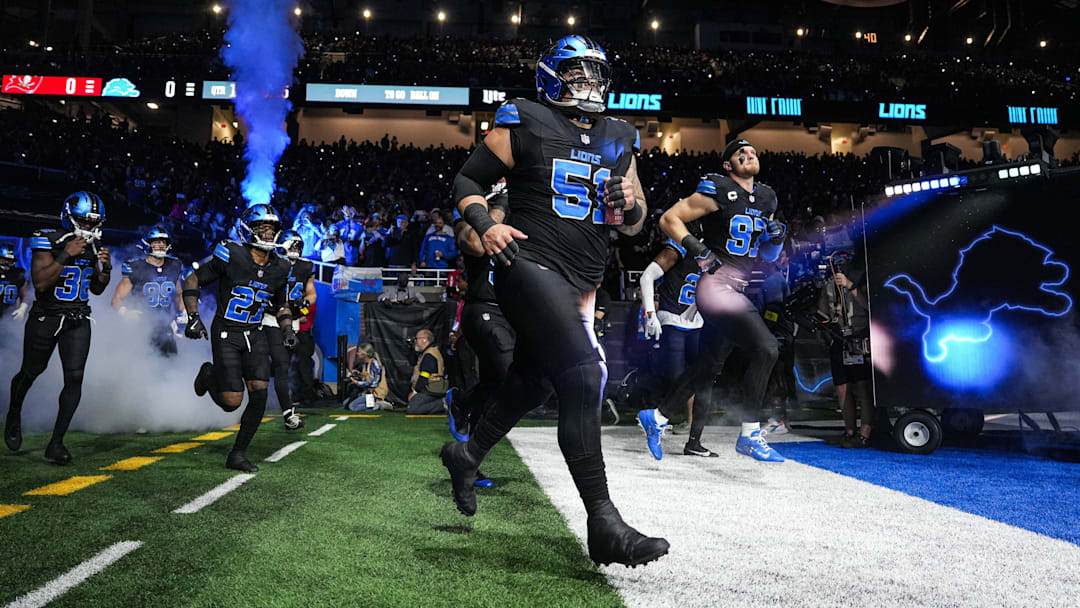 Detroit Lions defensive tackle Roy Lopez (51) and defensive end Aidan Hutchinson (97) run onto the field for the first half against the Tampa Bay Buccaneers at Ford Field in Detroit on Monday, Oct. 20, 2025.
