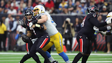Jan 11, 2025; Houston, Texas, USA; Los Angeles Chargers outside linebacker Joey Bosa (97) sacks Houston Texans quarterback C.J. Stroud (7) during the first quarter in an AFC wild card game at NRG Stadium. Mandatory Credit: Troy Taormina-Imagn Images