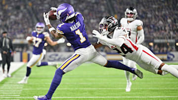 Sep 14, 2025; Minneapolis, Minnesota, USA; Minnesota Vikings wide receiver Jalen Nailor (1) runs for a touchdown as Atlanta Falcons cornerback A.J. Terrell Jr. (24) defends during the first half at U.S. Bank Stadium. Mandatory Credit: Jeffrey Becker-Imagn Images