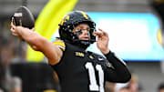 Oct 18, 2025; Iowa City, Iowa, USA; Iowa Hawkeyes quarterback Mark Gronowski (11) warms up before the game against the Penn State Nittany Lions at Kinnick Stadium. Mandatory Credit: Jeffrey Becker-Imagn Images