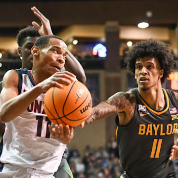 Dec 2, 2022; Sioux Falls, South Dakota, USA;  Gonzaga Bulldogs guard Nolan Hickman (11) drives on Baylor Bears forward Jalen Bridges (11) in the first half at Sanford Pentagon. Mandatory Credit: Steven Branscombe-Imagn Images