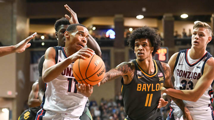 Dec 2, 2022; Sioux Falls, South Dakota, USA;  Gonzaga Bulldogs guard Nolan Hickman (11) drives on Baylor Bears forward Jalen Bridges (11) in the first half at Sanford Pentagon. Mandatory Credit: Steven Branscombe-Imagn Images