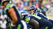 Nov 9, 2025; Seattle, Washington, USA;  Seattle Seahawks quarterback Sam Darnold (14) prepares to take a snap during the third quarter against the Arizona Cardinals at Lumen Field.