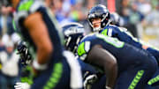 Nov 9, 2025; Seattle, Washington, USA;  Seattle Seahawks quarterback Sam Darnold (14) prepares to take a snap during the third quarter against the Arizona Cardinals at Lumen Field. Mandatory Credit: Steven Bisig-Imagn Images