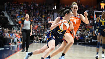 Sep 22, 2024; Uncasville, Connecticut, USA; Indiana Fever guard Caitlin Clark (22) dribbles the ball defended by Connecticut Sun guard Marina Mabrey (4).