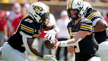 Missouri Tigers quarterback Beau Pribula (9) hands the ball off to running back Ahmad Hardy (29), in a game versus the Louisiana Ragin' Cajuns this season.