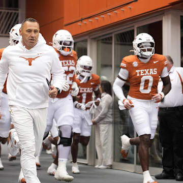 Texas Longhorns head coach Steve Sarkisian leads his team on to the field before a game against the Vanderbilt Commodores at Darrell K Royal-Texas Memorial Stadium. 