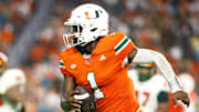 Sep 7, 2024; Miami Gardens, Florida, USA; Miami Hurricanes quarterback Cam Ward (1) runs with the football for a touchdown.