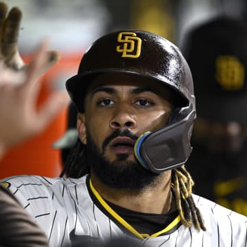 Jun 11, 2024; San Diego, California, USA; San Diego Padres right fielder Fernando Tatis Jr. (23) is congratulated in the dugout after scoring a run against the Oakland Athletics during the fifth inning at Petco Park. Mandatory Credit: Orlando Ramirez-USA TODAY Sports