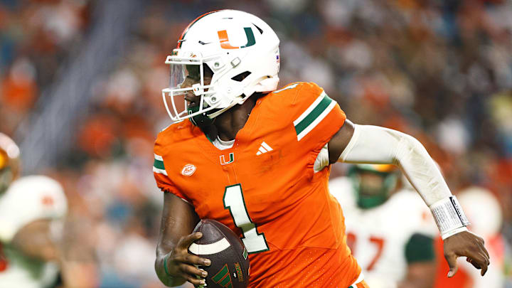 Sep 7, 2024; Miami Gardens, Florida, USA; Miami Hurricanes quarterback Cam Ward (1) runs with the football for a touchdown.