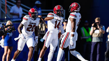 South Carolina football TE Michael Smith (20) and WR Jared Brown (14) celebrating a touchdown with TE Josh Simon (6)