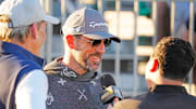 FeJets quarterback Aaron Rodgers talks with the press on the first tee box during the Phoenix Open Annexus Pro-Am at TPC Scottsdale.