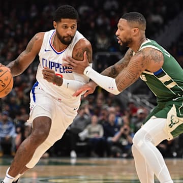 Mar 4, 2024; Milwaukee, Wisconsin, USA;  Los Angeles Clippers forward Paul George (13) drives for the basket against Milwaukee Bucks guard Damian Lillard (0) in the first quarter at Fiserv Forum. Mandatory Credit: Benny Sieu-Imagn Images