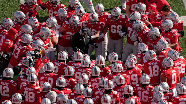 Ohio State Buckeyes head coach Ryan Day is surrounded by players before a game this season. Ohio State Buckeyes head coach Ryan Day is surrounded by players before a game this season.