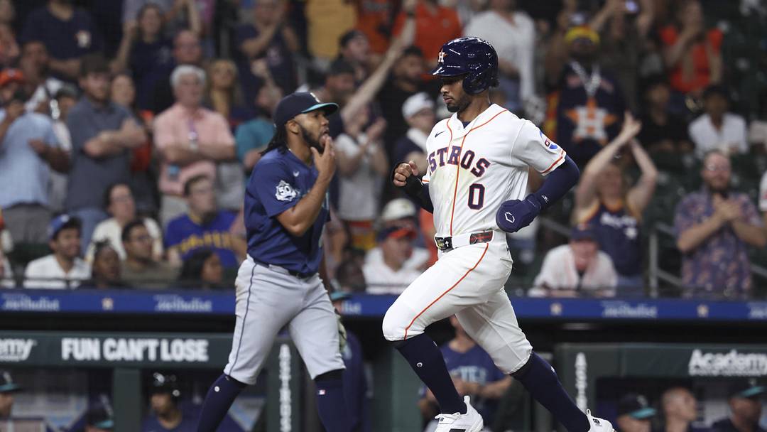 May 13, 2026; Houston, Texas, USA; Houston Astros center fielder Brice Matthews (0) runs past Seattle Mariners pitcher Eduard Bazardo (83) to score a run during the eighth inning at Daikin Park. Mandatory Credit: Troy Taormina-Imagn Images