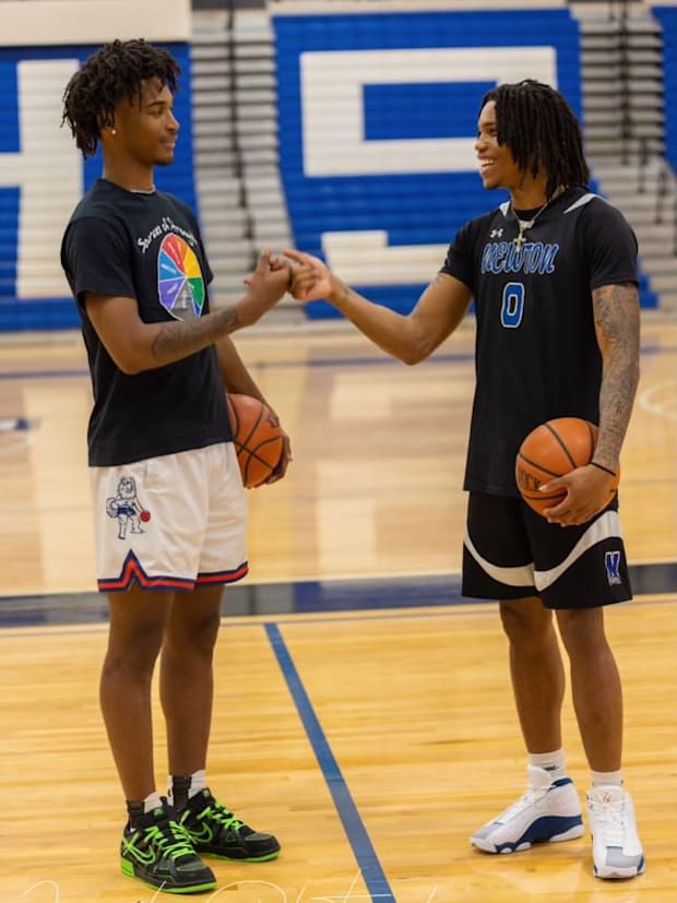 Stephon Castle (left) and Jakai Newton (right) shake hands during high school at the Newton High School gym.