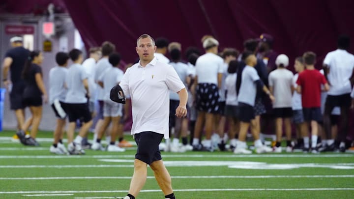 ASU head coach Kenny Dillingham looks over kids campers during an ASU annual kids football camp inside the Verde Dickey Dome in Tempe, Ariz. on June 11, 2025. ASU head coach Kenny Dillingham looks over kids campers during an ASU annual kids football camp inside the Verde Dickey Dome in Tempe, Ariz. on June 11, 2025.