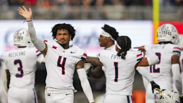 Nov 15, 2025; Cincinnati, Ohio, USA;  Arizona Wildcats wide receiver Kris Hutson (4) waves to fans as he celebrates with teammates in the game against the Cincinnati Bearcats in the second half at Nippert Stadium. Mandatory Credit: Aaron Doster-Imagn Images