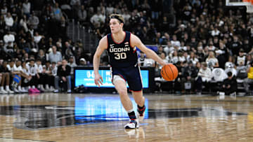 Mar 1, 2025; Providence, Rhode Island, USA; Connecticut Huskies forward Liam McNeeley (30) dribbles against the Providence Friars  during the second half at Amica Mutual Pavilion. Mandatory Credit: Eric Canha-Imagn Images