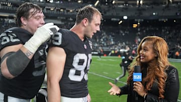 Dec 22, 2024; Paradise, Nevada, USA; CBS Sports sideine reporter AJ Ross interviews Las Vegas Raiders tight end Brock Bowers (89) and guard Jackson Powers-Johnson (58) after the game against the Jacksonville Jaguars Allegiant Stadium. Mandatory Credit: Kirby Lee-Imagn Images