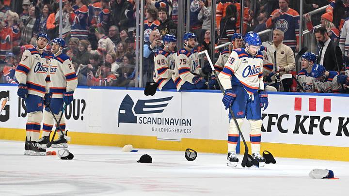 Dec 23, 2025; Edmonton, Alberta, CAN; Edmonton Oilers center Connor McDavid (97) with center Leon Draisaitl (29) look down at hats on the ice as they celebrate a goal against the Calgary Flames during the third period at Rogers Place. Mandatory Credit: Walter Tychnowicz-Imagn Images