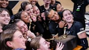 The Purdue Boilermakers pose with the trophy after winning the Monon Spike Match against the Indiana Hoosiers