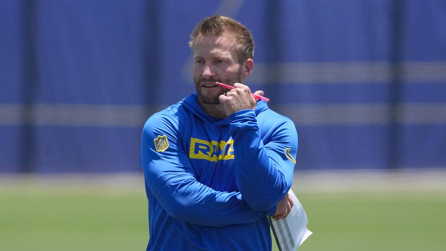 Sean McVay holds a pen and paper during a practice.