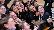 The Purdue Boilermakers pose with the trophy after winning the Monon Spike Match